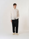 The Ecru/Navy/Sand Hendrix Stripe Square Pocket Shirt is shown as a flat lay against a plain white background. The shirt features a multi-colored vertical stripe pattern in ecru, navy, and sand. It has a classic button-down front, a structured collar, and two large square patch pockets on the chest.