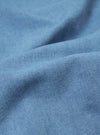 A close-up swatch of the Washed Indigo Recycled Herringbone Kyoto Work Jacket highlights the textured V-shaped herringbone weave of the denim fabric. The material features a light, washed indigo blue color with a soft, vintage appearance.