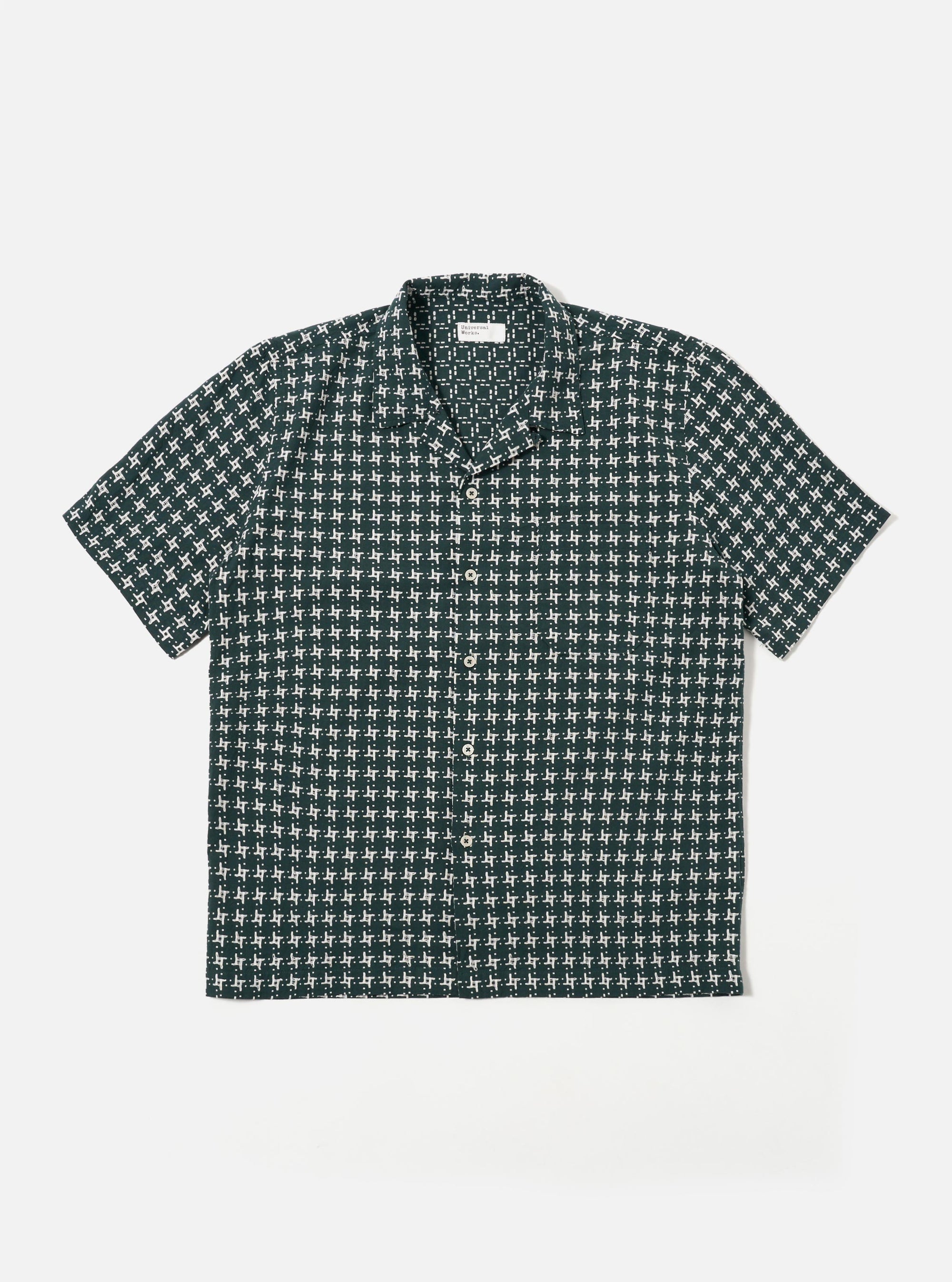 The Green/White Rhodes 8 Cotton Road Shirt is shown as a flat lay against a white background. The shirt features an all-over vertical stripe pattern in green and white, a camp collar, a central button-down closure, and two large chest patch pockets. The fabric has a visible textured weave.