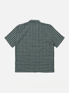 The Green/White Rhodes 8 Cotton Road Shirt is shown from a rear angle as a flat lay against a plain white background. The shirt features a green and white checkered pattern and a straight hem. The back panel is constructed with a simple, clean design highlighting the lightweight cotton fabric.