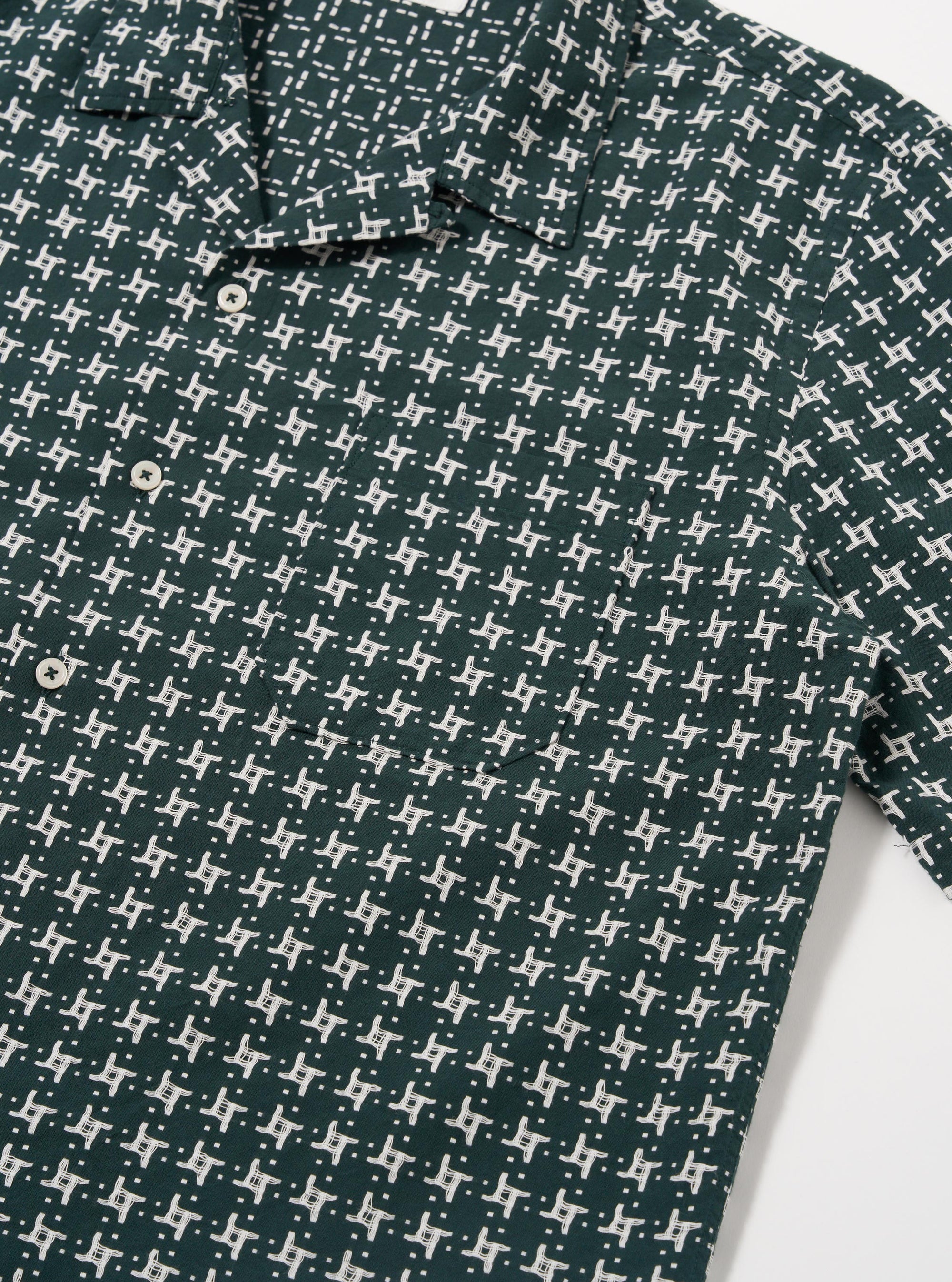 The Green/White Rhodes 8 Cotton Road Shirt is shown from the back as a flat lay against a plain white background. The image highlights the short-sleeve construction, straight hem, and the vertical striped pattern in green and white. The one-piece collar and the smooth texture of the cotton fabric are visible.