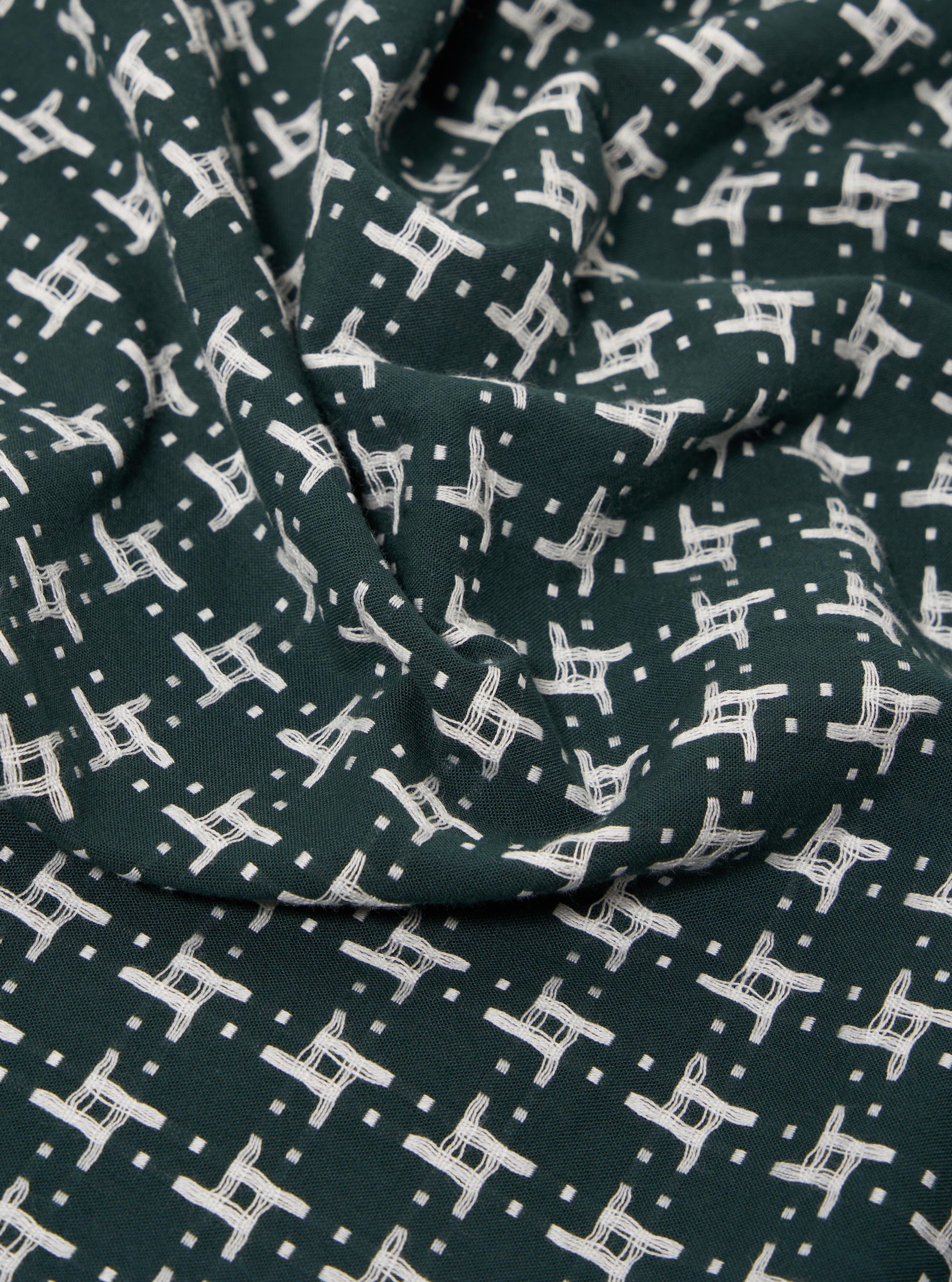 The Green/White Rhodes 8 Cotton Road Shirt is displayed as a flat lay against a plain white background. The shirt features a prominent green and white checkered pattern and is designed with a relaxed camp collar and short sleeves. It has a central button-down front and a single patch pocket on the left chest. The fabric appears lightweight with a textured cotton finish.