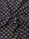 A close-up fabric swatch of the Navy/Sand Rhodes 8 Cotton Road Shirt highlights the intricate woven pattern. The textile features a repeating geometric design in navy blue and sand tones.