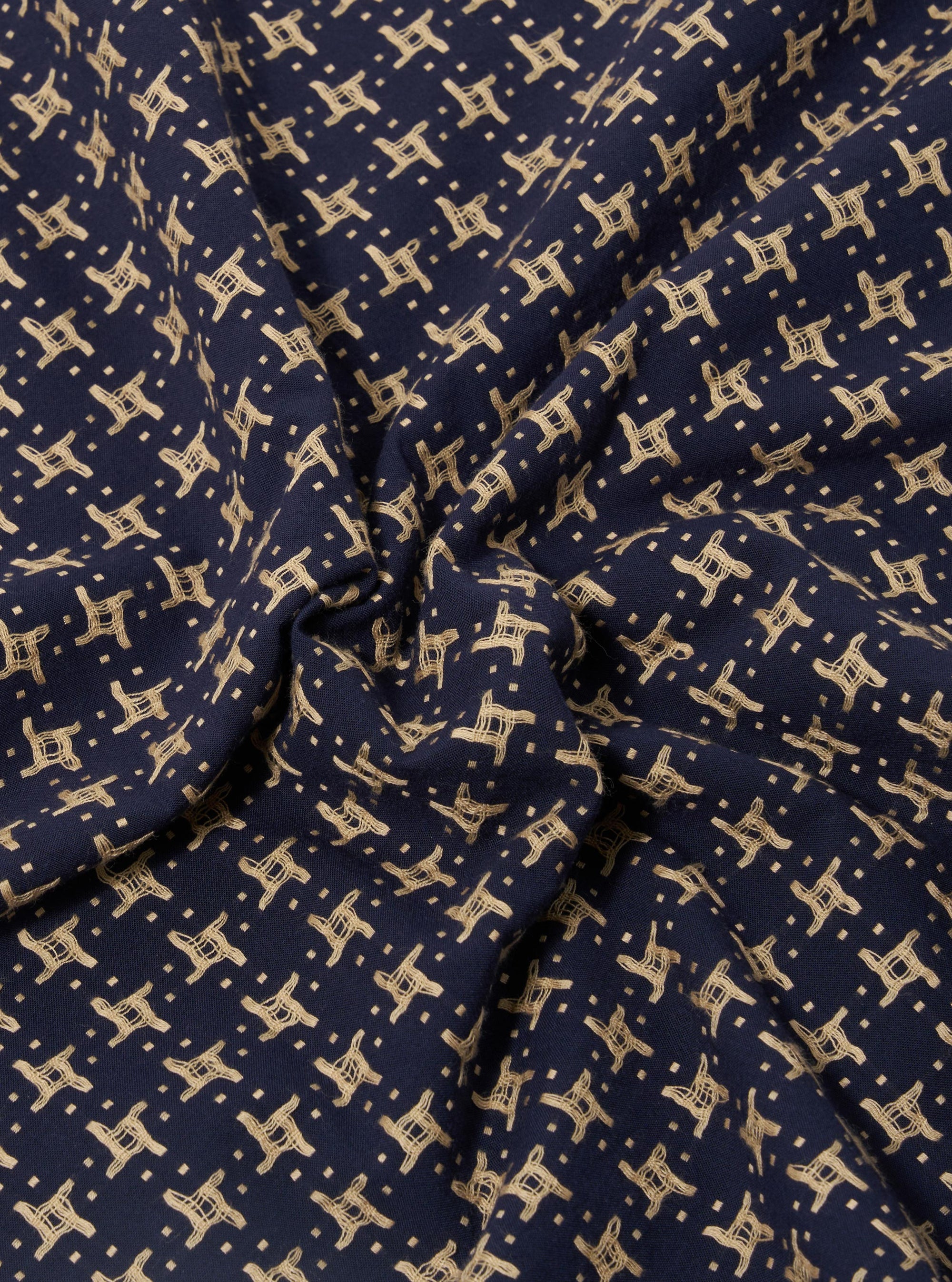 A close-up fabric swatch of the Navy/Sand Rhodes 8 Cotton Road Shirt highlights the intricate woven pattern. The textile features a repeating geometric design in navy blue and sand tones.