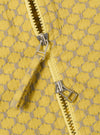 The Yellow Mykonos Cotton Zip Shirt is shown in a detail view as a flat lay against a plain white background. The image highlights the textured weave of the yellow cotton fabric and the metal zip-front closure.