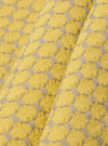 A close-up fabric swatch of the Yellow Mykonos Cotton Zip Shirt highlights the textured cotton material featuring a vibrant yellow and white patterned weave. The fabric fills the frame, providing a detailed view of the garment's color and construction.