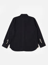 The Black Kendal Cotton Travail Overshirt is shown from the back as a flat lay against a plain white background. The image highlights the garment's loose, unstructured fit, curved hem, and a simple one-piece back panel. The black Kendal cotton fabric has a smooth, solid finish.