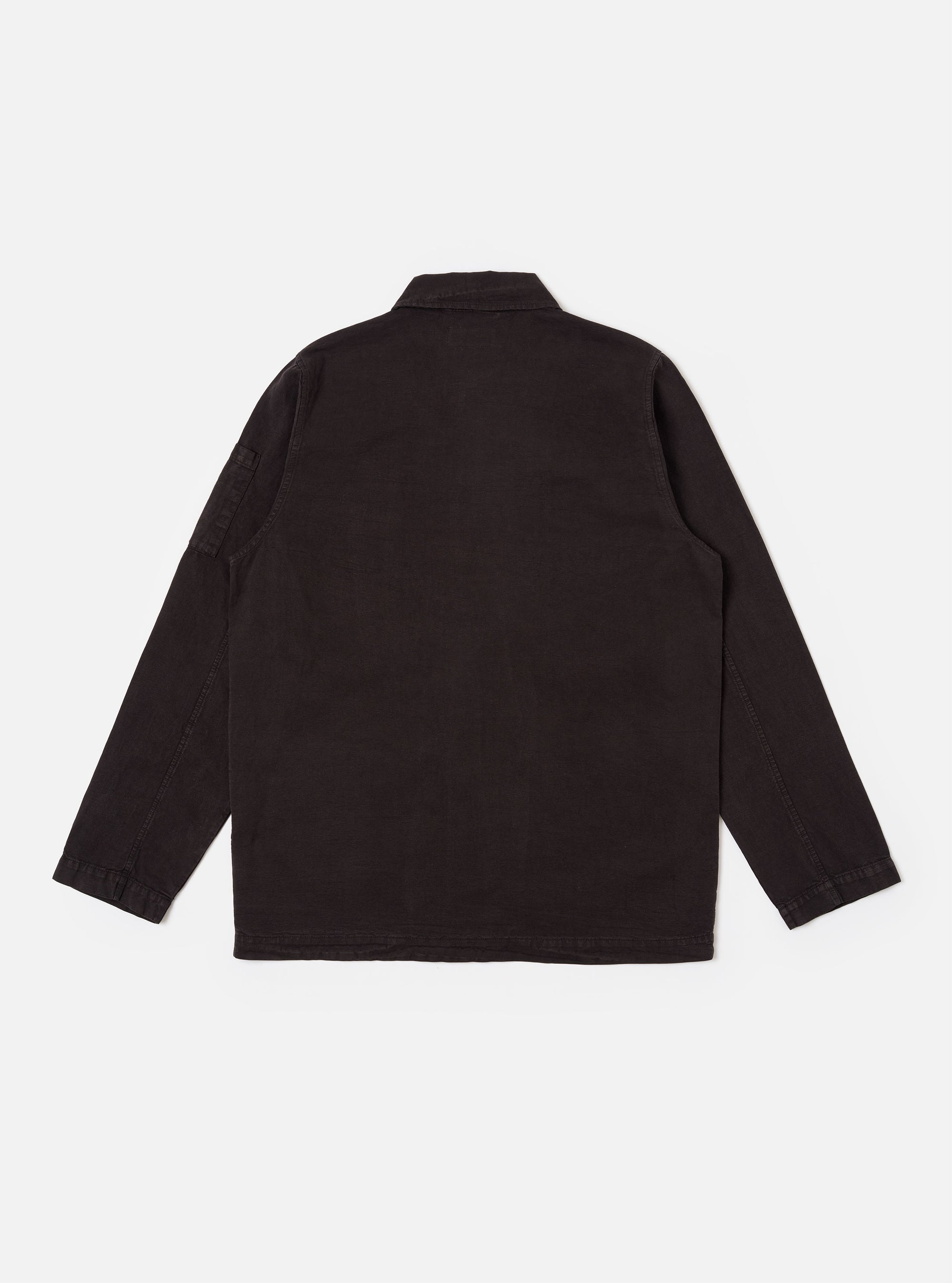 The Licorice Lyo Linen Mix Coverall Jacket is shown from the back as a flat lay against a plain white background. The image highlights the simple, clean construction of the garment's rear, the straight hem, and the dark brown textured fabric. A small pen pocket is visible on the upper left sleeve.