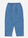 The Washed Indigo 8oz Slub Denim Oxford Pant is shown as a flat lay against a white background. The trousers feature a wide-leg fit, a drawstring elasticated waistband, and a single pleat on each leg. The 8oz slub denim fabric has a visible textured, light blue washed indigo finish.