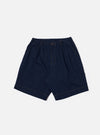The Indigo Recycled Herringbone Pleated Track Short is shown as a flat lay against a white background. The shorts feature a visible herringbone weave pattern in indigo blue, front pleats, and an elasticated waistband with an adjustable drawstring.