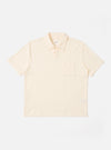 The Ecru Light Weight Terry Newlyn Polo is shown as a flat lay against a white background. The polo features a classic collar, a short button placket, and short sleeves. The fabric has a visible textured light weight terry finish in a soft ecru color.