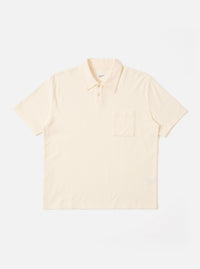 The Ecru Light Weight Terry Newlyn Polo is shown as a flat lay against a white background. The polo features a classic collar, a short button placket, and short sleeves. The fabric has a visible textured light weight terry finish in a soft ecru color.