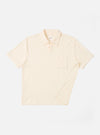 The Ecru Light Weight Terry Newlyn Polo is shown as a flat lay against a white background. The shirt features a polo collar, a three-button front closure, and a single patch pocket on the left chest. The garment is made from a light-colored terry fabric with a soft, fluffy texture.