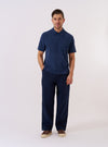 The Navy Light Weight Terry Newlyn Polo is shown as a flat lay against a white background. The polo features a simple one-piece collar, a three-button placket, and a large chest pocket on the left side. The fabric has a soft, textured terry finish, and the hem is split at the sides.