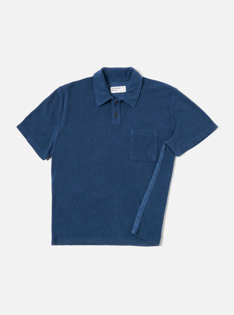The Navy Light Weight Terry Newlyn Polo is shown as a flat lay against a white background. The polo features a simple one-piece collar, a large patch pocket on the left chest, and short sleeves. The fabric has a fine terry texture in a deep navy blue.