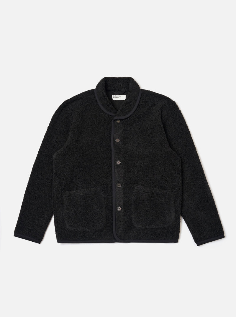 The Black Alvar Fleece Lancaster Jacket is shown as a flat lay against a plain white background. The jacket features a textured black fleece fabric, a rounded shawl-style collar, and a five-button front closure. It includes two large patch pockets at the waist and a single patch pocket on the left chest.