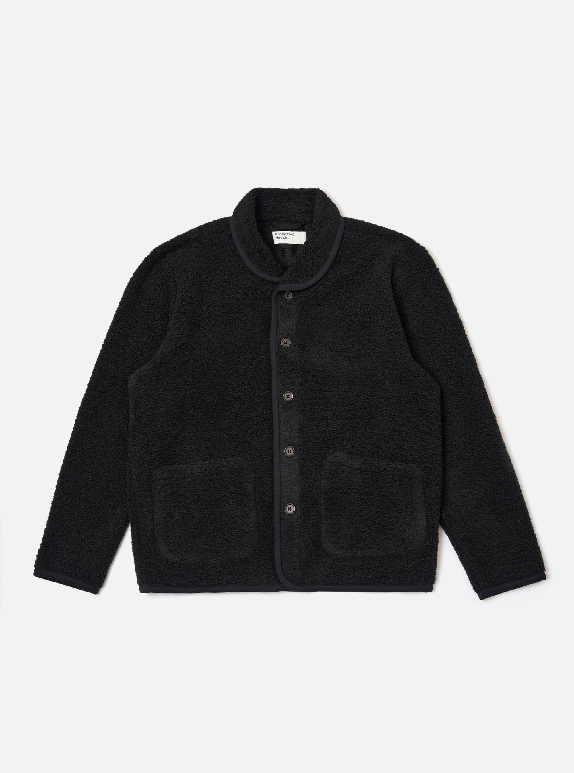 The Black Alvar Fleece Lancaster Jacket is shown as a flat lay against a plain white background. The jacket features a textured black fleece fabric, a rounded shawl-style collar, and a five-button front closure. It includes two large patch pockets at the waist and a single patch pocket on the left chest.