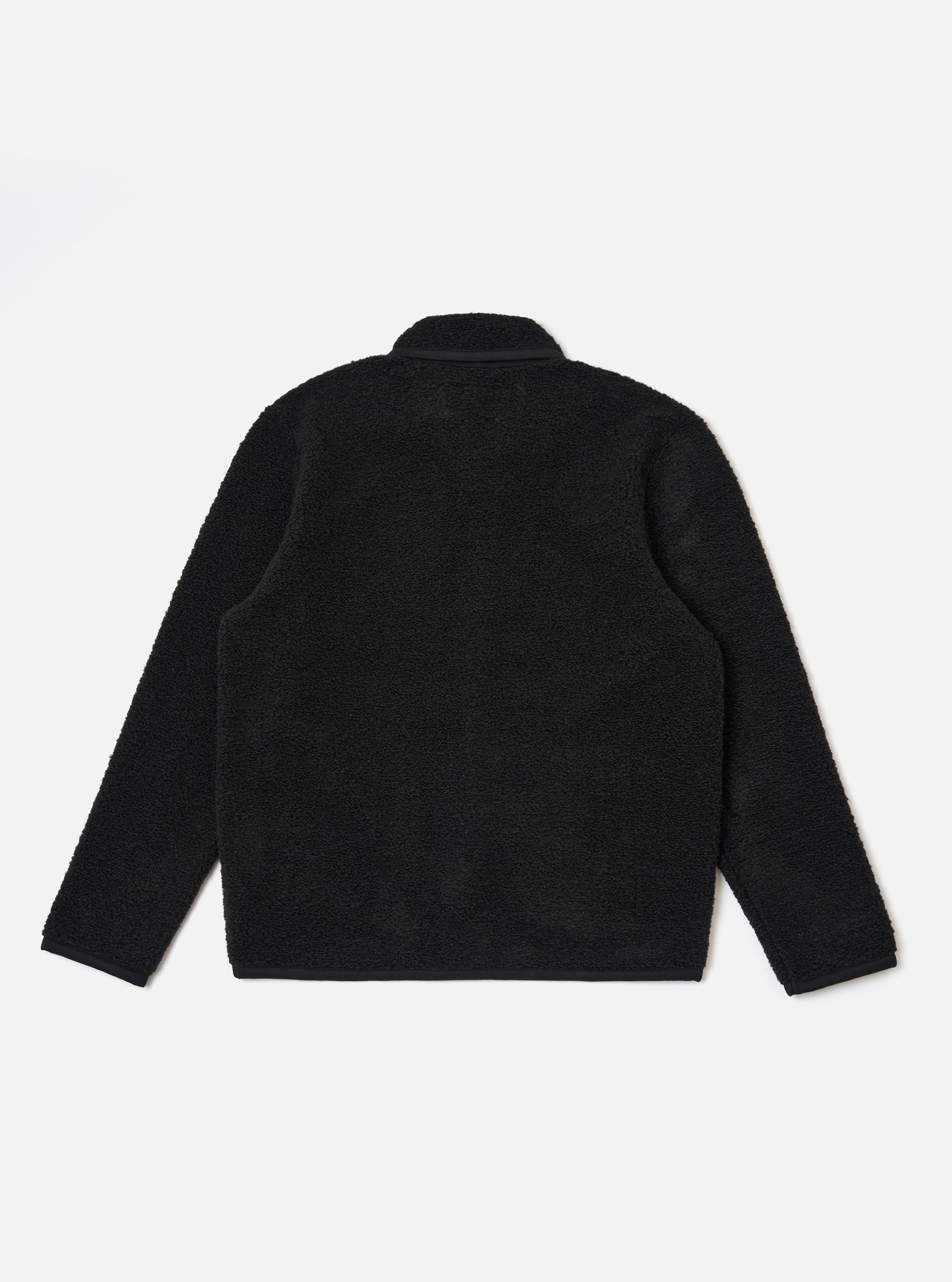 The Black Alvar Fleece Lancaster Jacket is shown from the back as a flat lay against a plain white background. The image highlights the jacket's textured black fleece fabric, a curved hem, and a simple one-piece back panel.