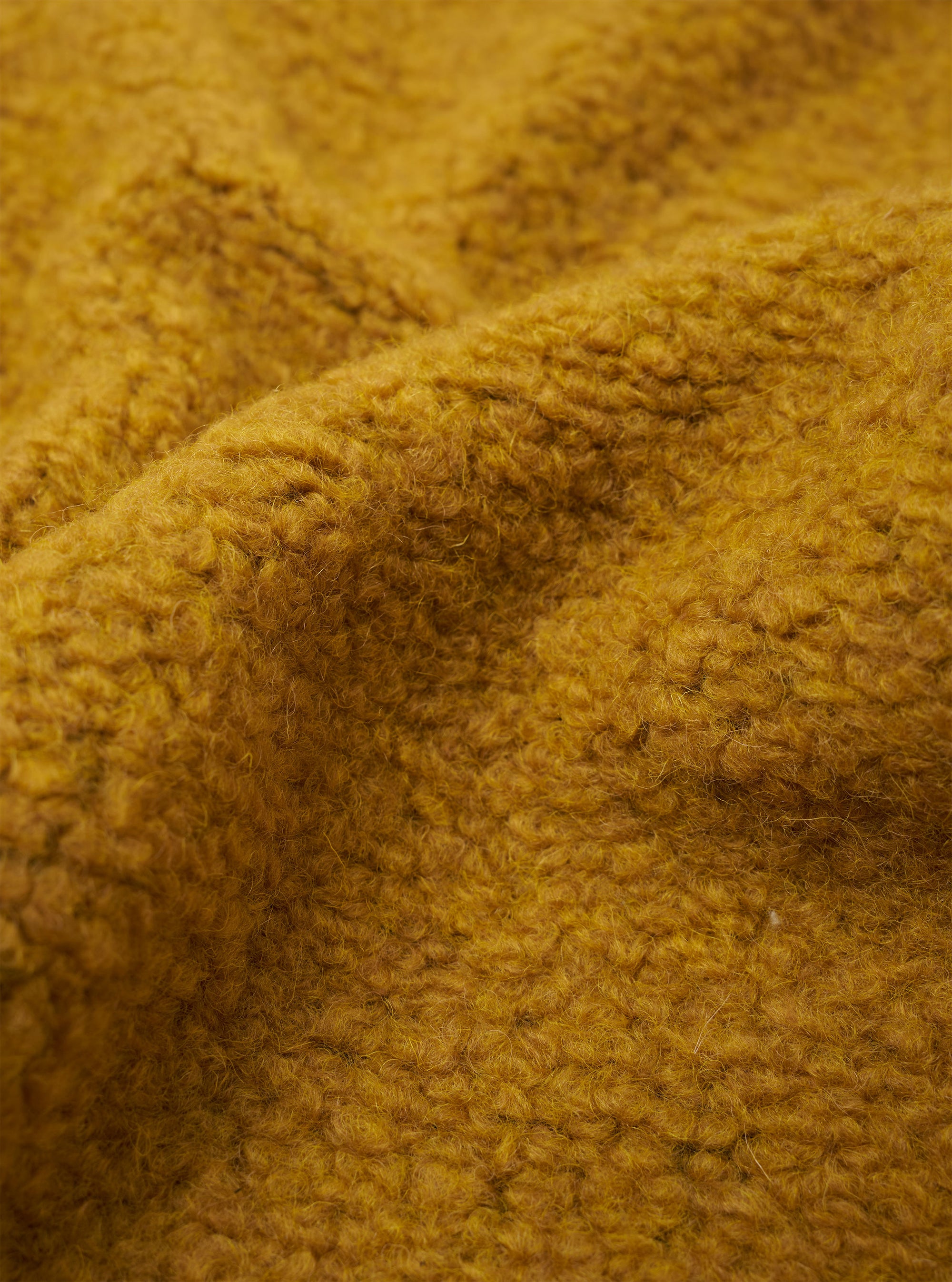 A close-up fabric swatch of the Yellow Alvar Fleece Lancaster Jacket is displayed, highlighting the thick and curly texture of the yellow fleece material. No background, model, or mannequin is present in the image.