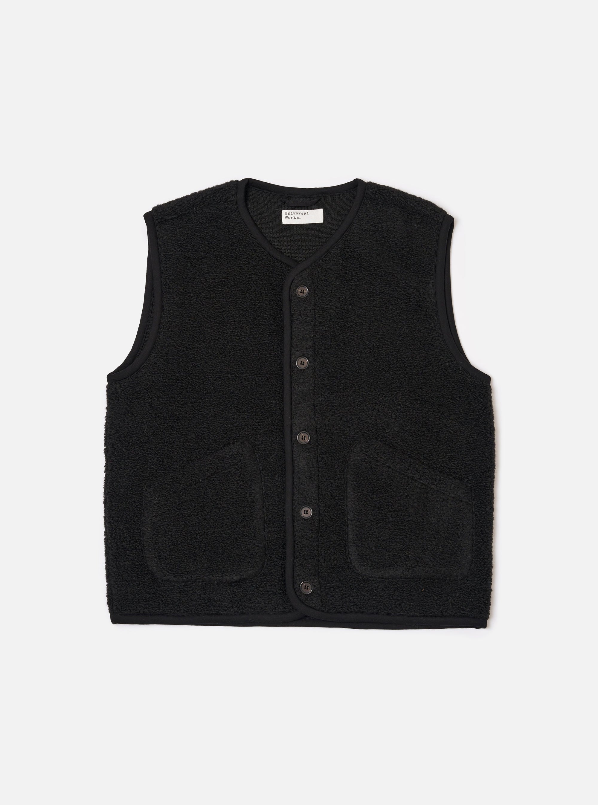 The Black Alvar Fleece Lancaster Gilet is shown as a flat lay against a plain white background. The gilet features a textured, fuzzy black fleece fabric, a five-button front closure, and a rounded shawl-style collar. It includes two large patch pockets at the waist and a single patch pocket on the left chest.
