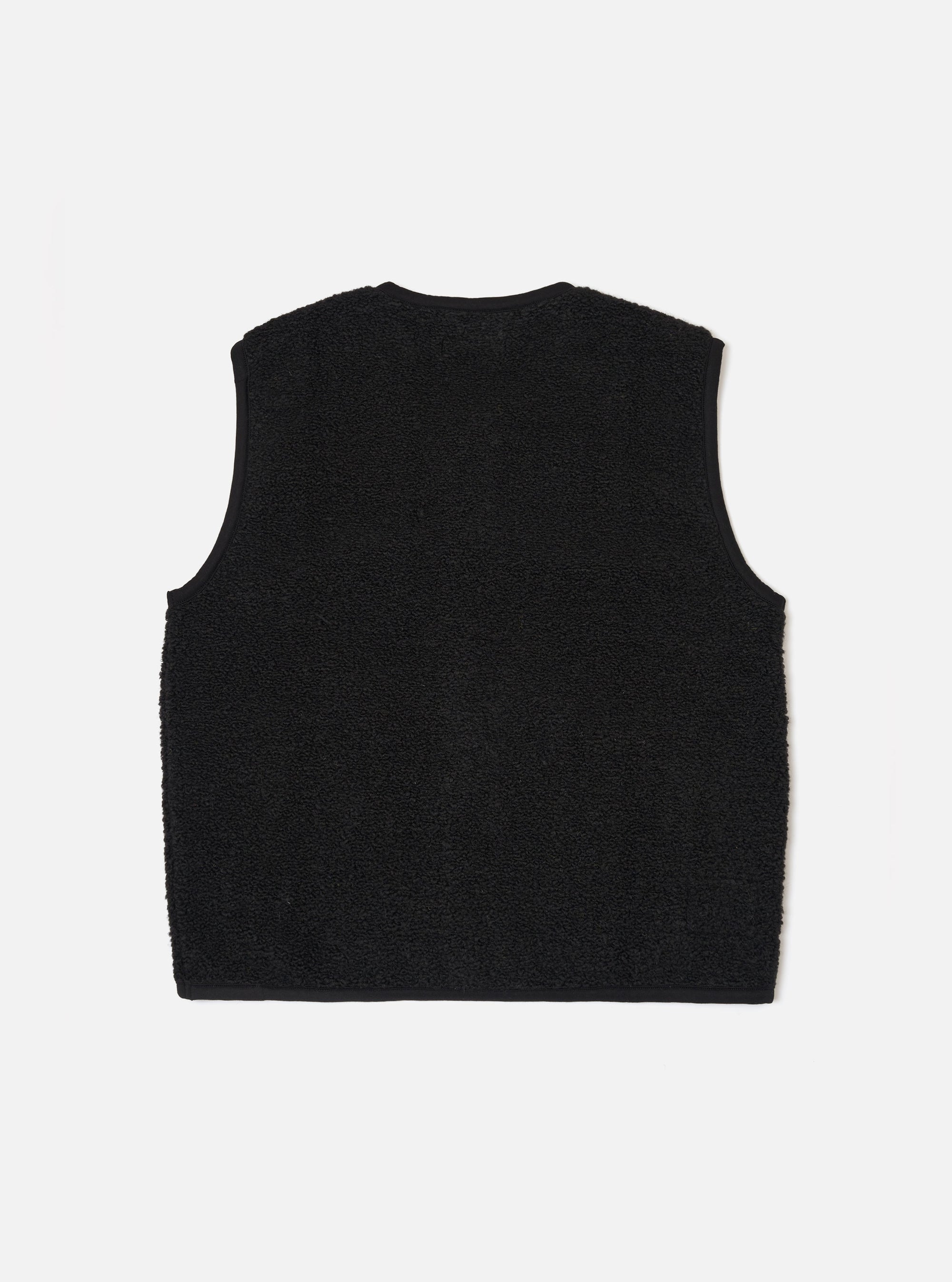 The Black Alvar Fleece Lancaster Gilet is shown from the back as a flat lay against a plain white background. The image highlights the garment's textured black fleece fabric, a simple one-piece back panel, and a curved hemline.