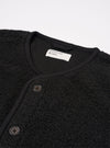 The Black Alvar Fleece Lancaster Gilet is shown as a flat lay against a plain white background. The gilet features a fuzzy black fleece texture, a central button-down front closure, and a rounded shawl-style collar. It includes two large patch pockets at the waist and a single patch pocket on the left chest.