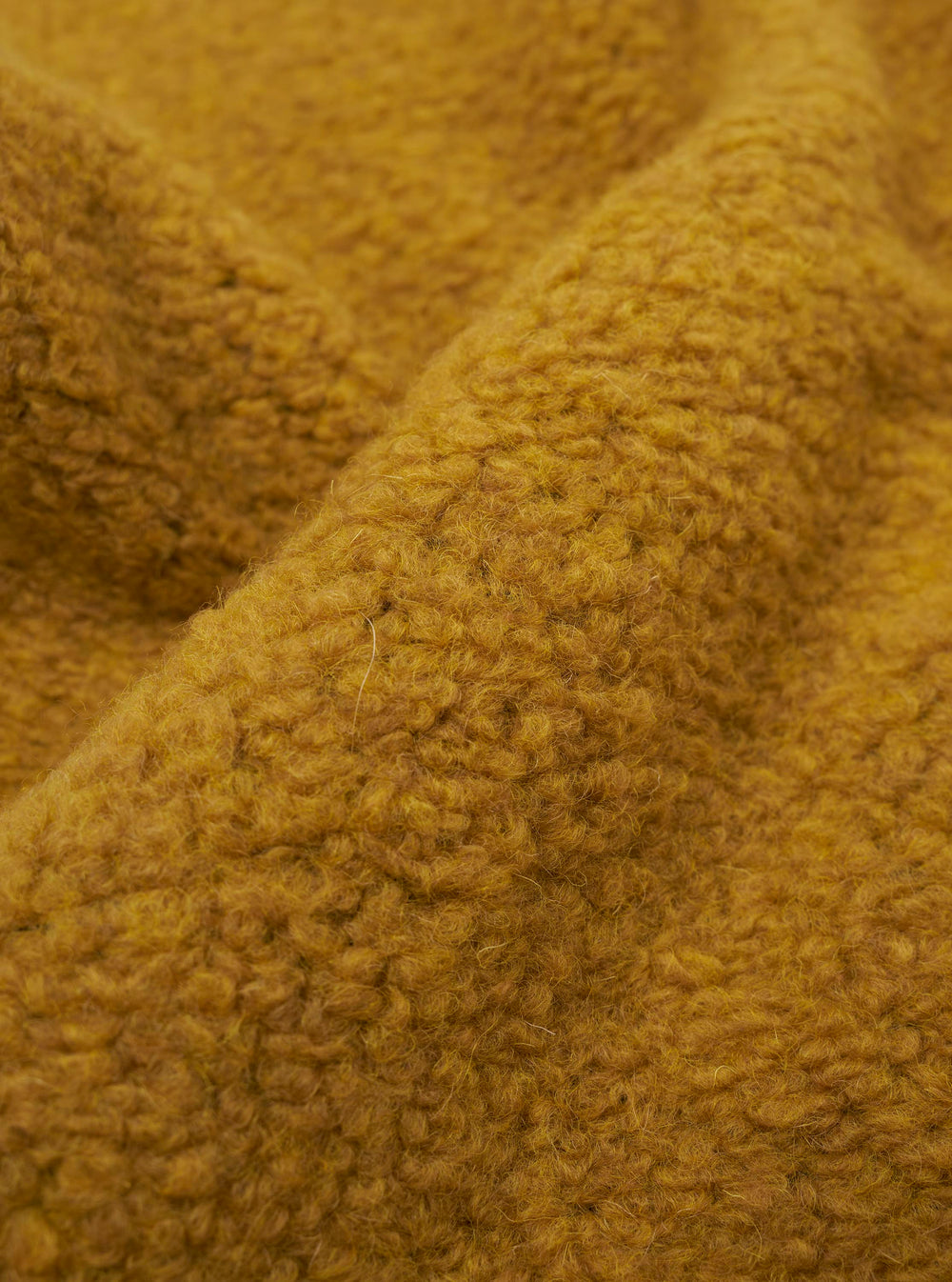 A close-up fabric swatch of the Yellow Alvar Fleece Lancaster Gilet highlights the thick, curly texture and brushed pile of the yellow fleece material.