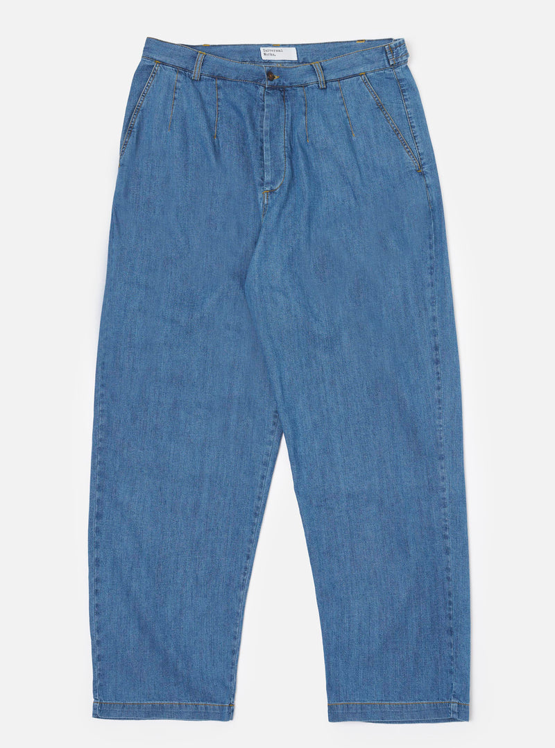The Washed Indigo 8oz Slub Denim Dutch Pant is shown as a flat lay against a white background. The trousers feature a wide-leg silhouette, an elasticated waistband with side button adjusters, and a button fly. The 8oz slub denim fabric has a visible textured grain in a washed indigo blue.