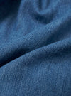 A close-up swatch of the Washed Indigo 8oz Slub Denim Dutch Pant highlights the deep indigo blue color and the highly textured slub finish. The image provides a detailed view of the vintage-like, broken texture and visible grain of the 8oz recycled cotton denim.