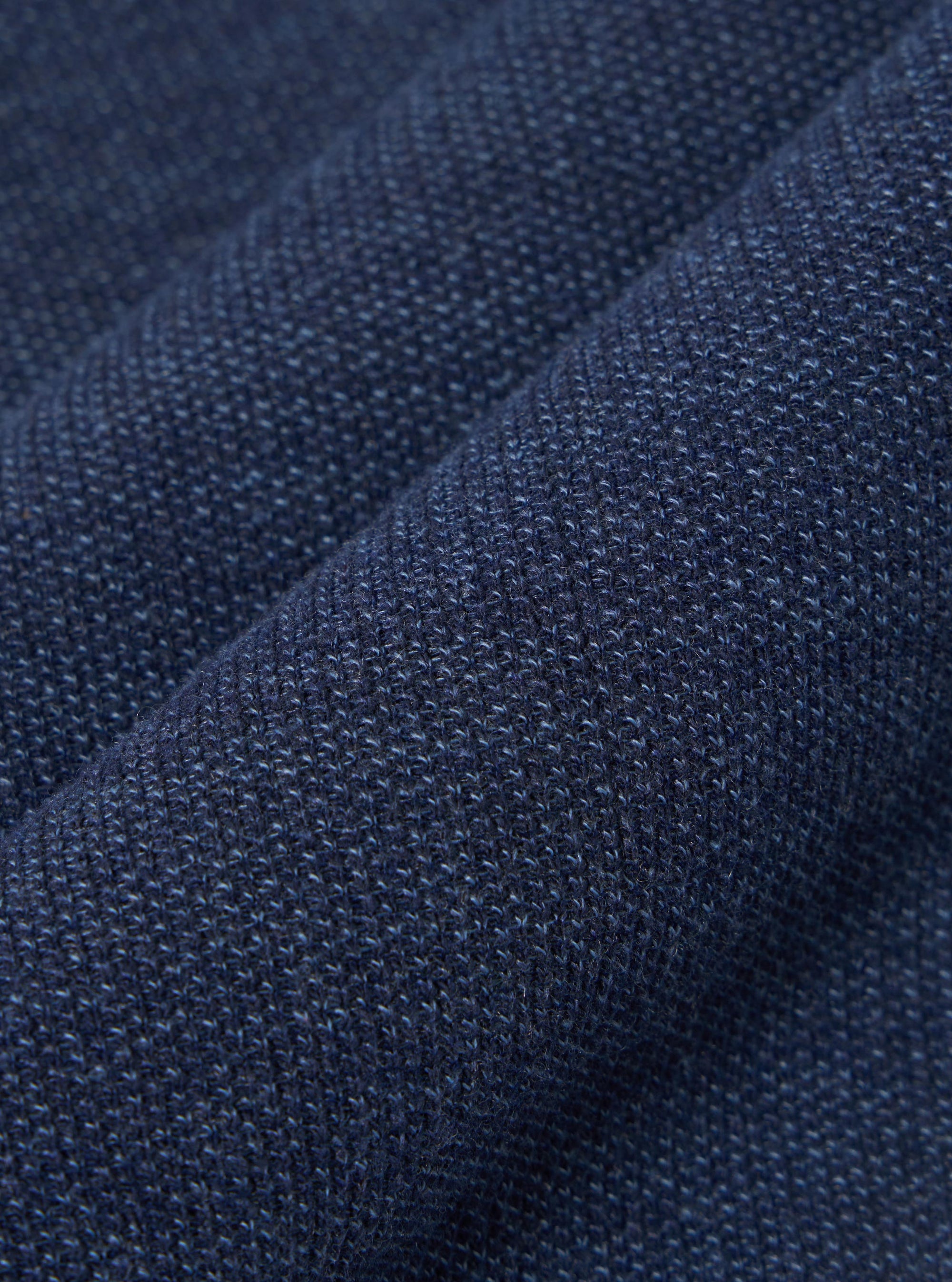 A close-up swatch image of the Navy Maiorca Jersey Cardigan fabric highlights a textured, woven pattern in a deep navy blue. The fabric has a distinct interlaced appearance with subtle variations in color.