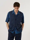 A model wears the Navy Maiorca Jersey Zip Gilet over a light-colored long-sleeve shirt against a plain white background. The gilet features a full-length front zipper, two slanted side pockets, and a ribbed collar. The textured jersey fabric in a deep navy blue is the prominent feature of the garment.