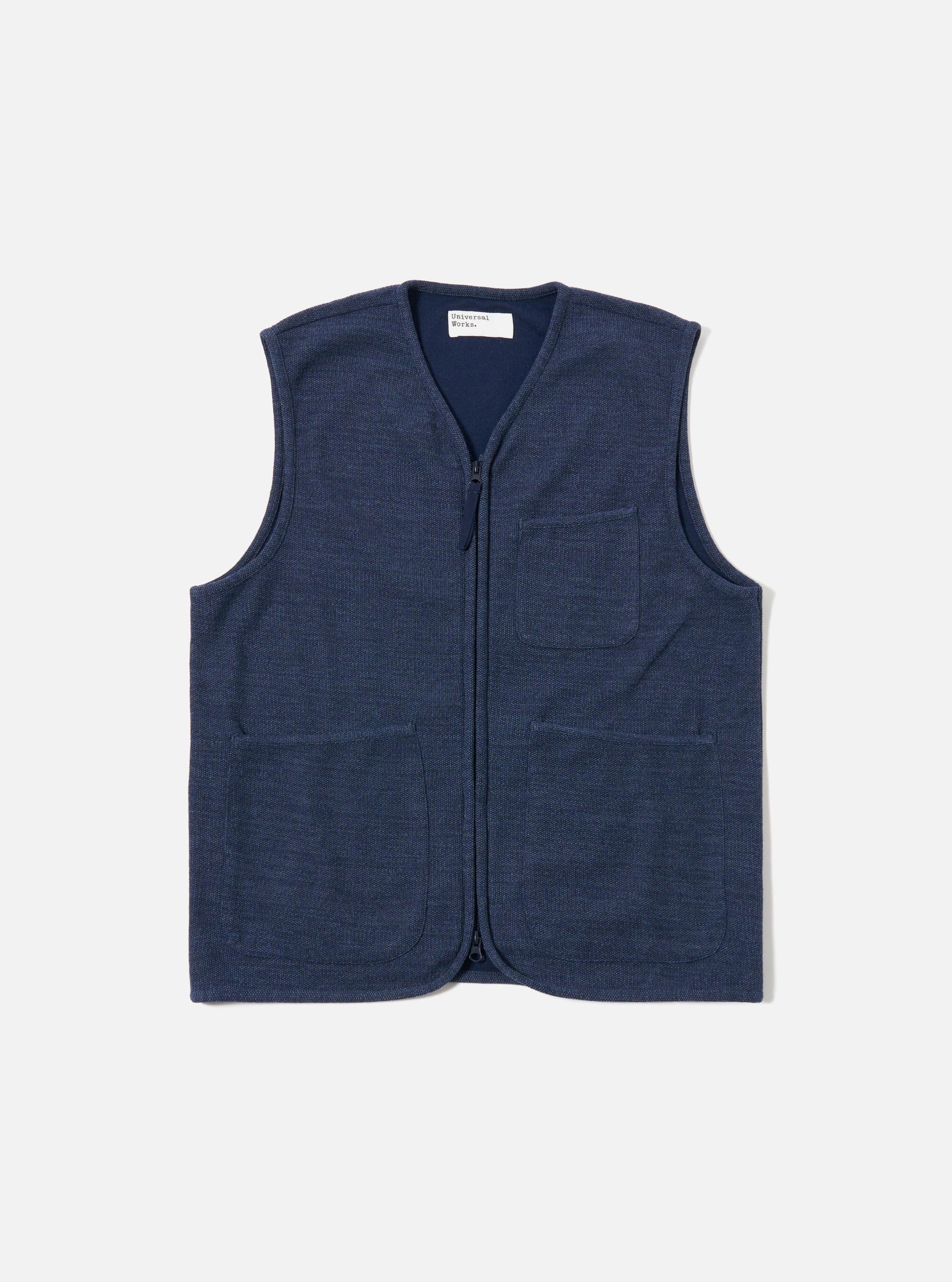 The Navy Maiorca Jersey Zip Gilet is presented as a flat lay against a plain white background. The gilet features a central zip-front closure and two large patch pockets at the waist. The navy blue garment is made from a textured jersey fabric and finished with a simple, clean neckline.