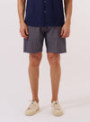 A model wears the Navy Konos Cotton Simple Short, shown from the waist down against a plain white background. The shorts feature a relaxed fit, an elasticated waistband, and side pockets. The navy fabric has a visible textured woven pattern throughout.