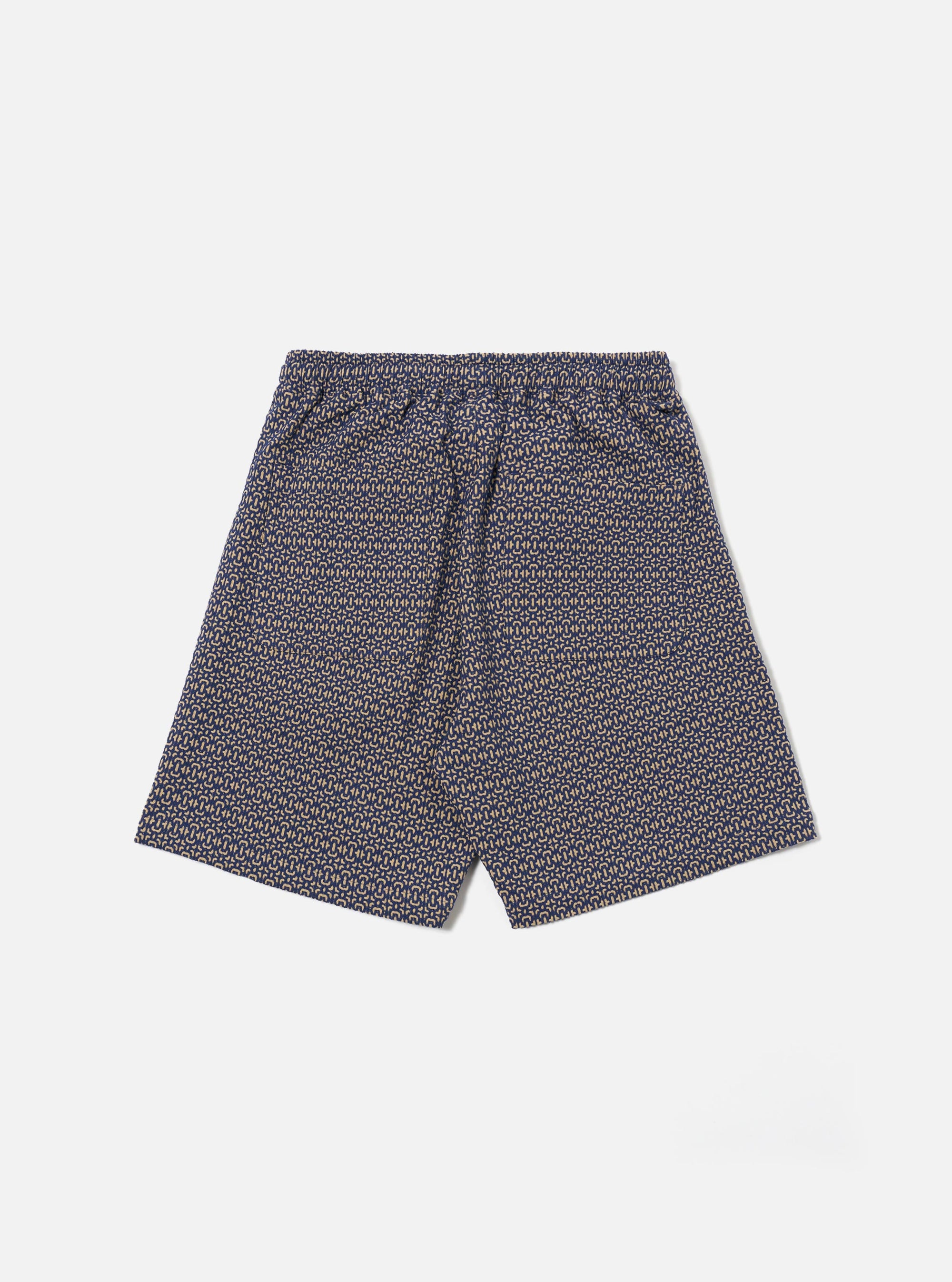 The Navy Konos Cotton Simple Short is shown from the back as a flat lay against a plain white background. The shorts feature a single rear patch pocket on the right side and a visible elasticated waistband with stitching details. The navy blue cotton fabric has a subtle, clean texture.