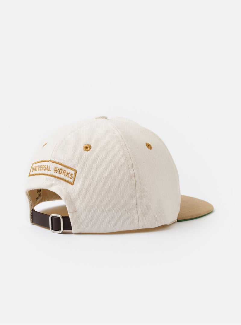 The Ecru/Sand Canvas Baseball Hat is shown as a flat lay against a white background. The 6-panel cap features a prominent wide peak in a contrasting sand color, while the crown is ecru. An adjustable strap with a metal buckle is visible at the rear.