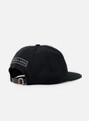 The Black Canvas Baseball Hat is shown from the rear in a flat lay against a plain white background. The image highlights the adjustable strap with a metal buckle and the structured back panels of the cap. The fabric is a solid black cotton canvas.