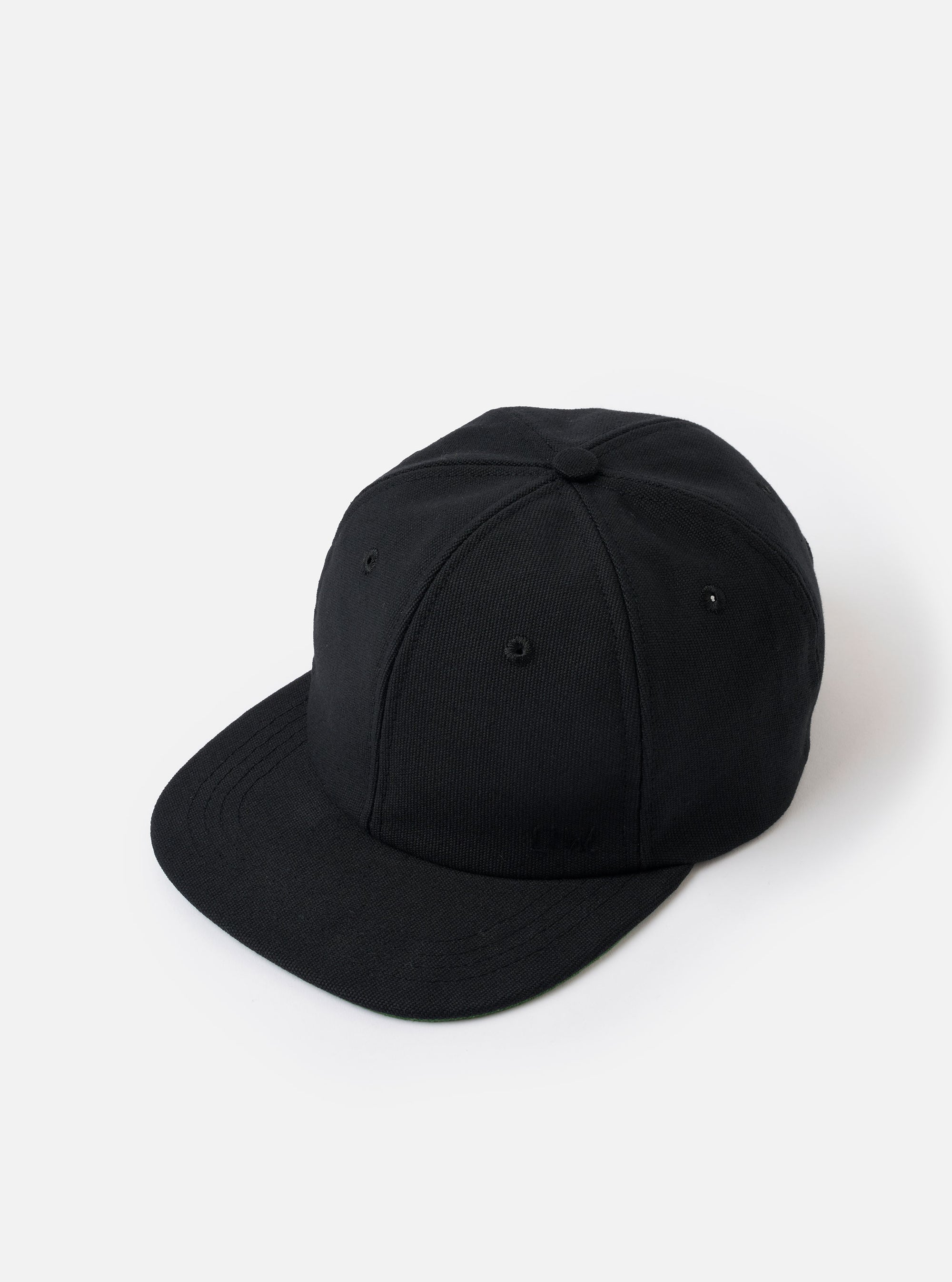 The Black Canvas Baseball Hat is shown from the rear as a flat lay against a plain white background. The image highlights the adjustable fabric strap with a metal buckle and the curved opening at the back. The hat is constructed from a solid black cotton canvas with tonal stitched eyelets visible on the rear panels.