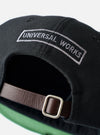 The Black Canvas Baseball Hat is shown from the back as a flat lay against a plain white background. The image highlights the adjustable fabric strap with a metal buckle and the structured six-panel construction of the black cotton canvas crown.