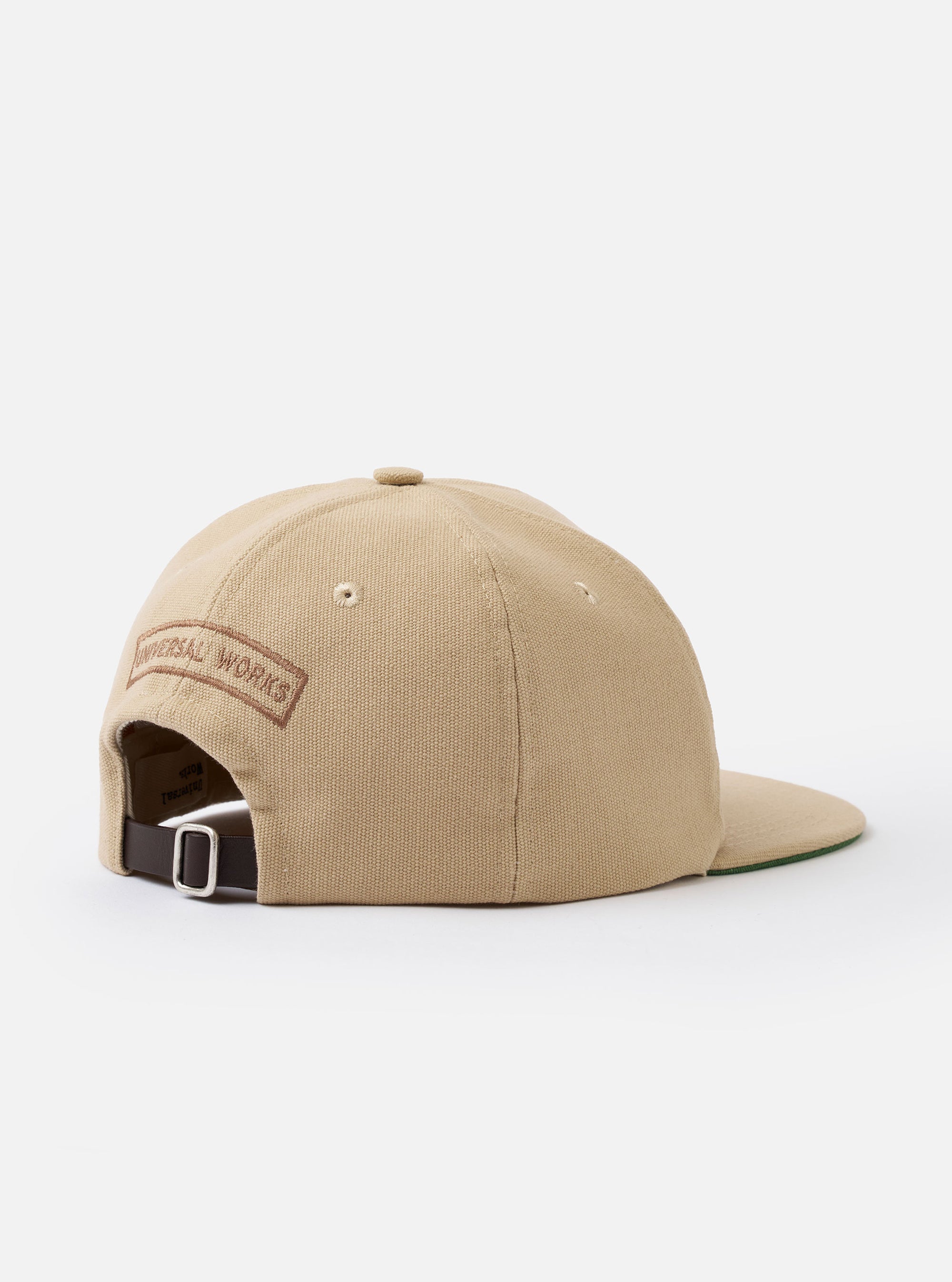 The Sand Canvas Baseball Hat is shown from the back as a flat lay against a plain white background. The image highlights the adjustable strap with a metal buckle and the rear construction of the six-panel crown. The sand-colored canvas fabric features visible tonal stitching.