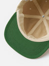The Sand Canvas Baseball Hat is shown from the back as a flat lay against a plain white background. The image highlights the adjustable fabric strap and the rear opening of the cap. The sand-colored cotton canvas material features visible tonal stitching and a structured six-panel design.