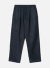 Navy wool mix oxford trousers in a tonal dark blue glen plaid. Elasticated waistband with a single metal button fastening at centre front, twin pleats, and slant side pockets. Wide straight leg with plain hem. Flat lay on a light grey seamless backdrop.