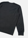 Black long-sleeve pocket tee in recycled wool mix fabric, shown as a flat lay on a white surface. The rear view shows the back panel, right shoulder seam, and full-length sleeve with a ribbed cuff at the wrist. A crew neckline is partially visible at the top. The fabric has a fine, lightly textured surface with a matte finish.