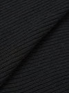 Close-up of black eco wool fabric showing a chunky waffle-knit texture with horizontal ribbing. The material is folded to reveal depth and dimension in the knit structure. Individual yarn fibres are visible across the surface.