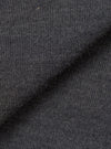 Close-up of the charcoal merino knit fabric, showing a fine, uniform jersey stitch with a soft, slightly textured surface. The dark grey tone has a subtle heathered quality. The fabric is folded to display drape and thickness against a plain white background.