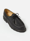 Studio shot of a Paraboot Black Leather Michael Marche II shoe. The black leather shoe features a lace-up closure and a thick sole with visible stitching, set against a clean white backdrop.