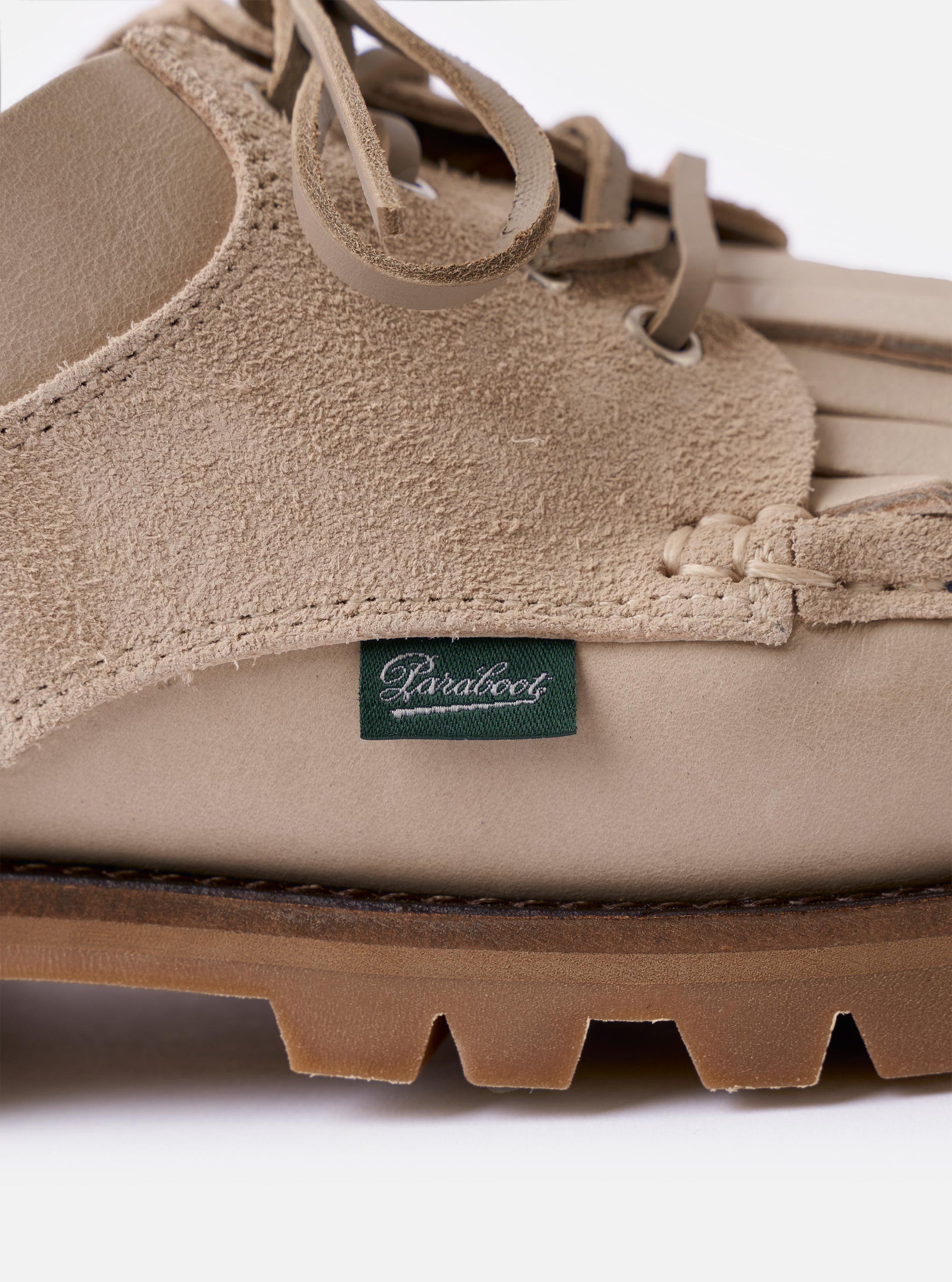The Paraboot x Universal Works Thiers/Jannu in Sand Leather/Suede is shown from the back as a flat lay against a plain white background. The image highlights the light beige rubber sole, the smooth leather heel counter with a central vertical seam, and the textured suede-like finish of the upper.