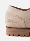 The Paraboot x Universal Works Thiers/Jannu in Sand Leather/Suede is shown from a side profile as a flat lay against a white background. The shoe features a combination of smooth sand-colored leather and textured suede, with four metal eyelets and light-colored laces. It has a chunky, lugged natural rubber sole with visible Blake stitch construction.