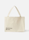 Studio shot of an Ecru Cotton Canvas Tote Bag against a white background. The bag has black text and ecru straps.