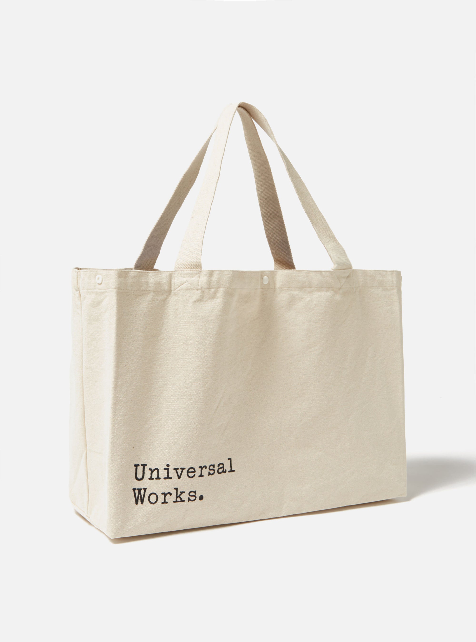Studio shot of an Ecru Cotton Canvas Tote Bag. The bag is ecru colored with matching handles. The background is a simple white.