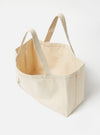 Studio shot of an Ecru Cotton Canvas Tote Bag. The bag is a light beige color and made of a thick canvas material. The background is a plain white.